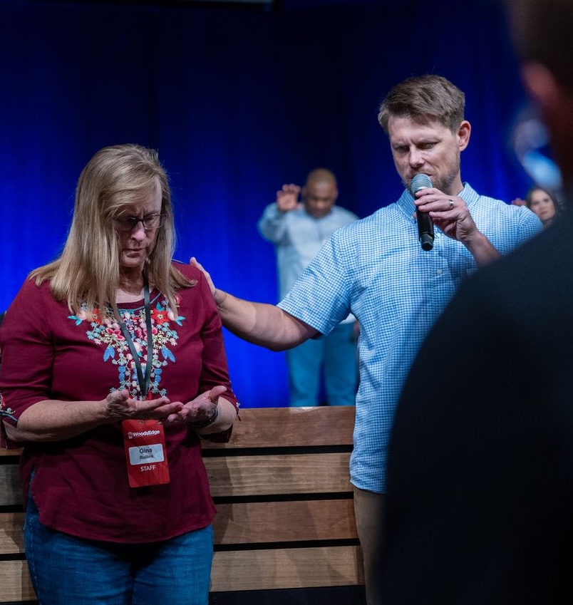 Michael Rowntree praying over someone at a conference